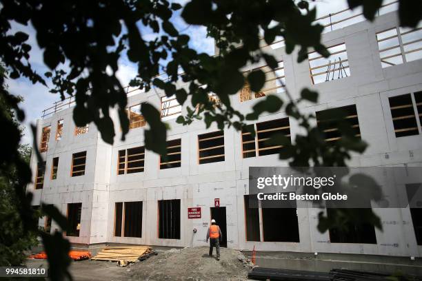 An apartment complex is pictured under construction at the site of a building that burned down last summer on Cooper Street in Waltham, MA on June 7,...