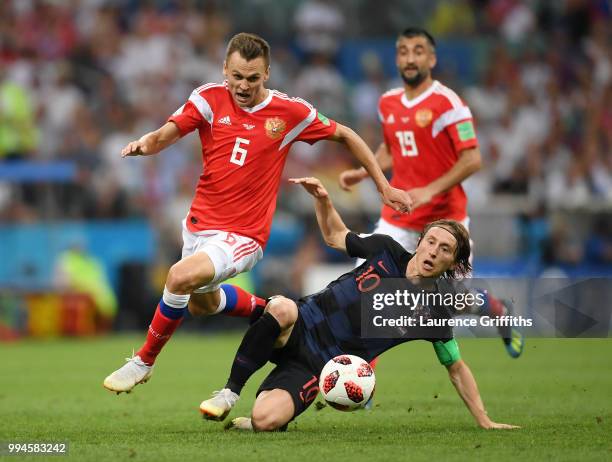 Denis Cheryshev of Russia is tackled by Luka Modric of Craotia during the 2018 FIFA World Cup Russia Quarter Final match between Russia and Croatia...