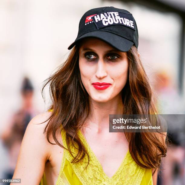 Anna Cleveland wears a cap with a patch depicting "Haute Couture" , outside Jean-Paul Gaultier, during Paris Fashion Week Haute Couture Fall Winter...