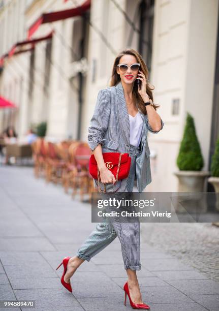 Alexandra Lapp wearing a checkered suit combination in black and white with a long blazer and high waist pants with an integrated belt both from...