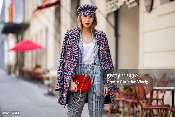 Alexandra Lapp wearing a checkered suit combination in black and white with a long blazer and high waist pants with an integrated belt both from...