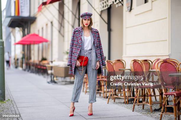 Alexandra Lapp wearing a checkered suit combination in black and white with a long blazer and high waist pants with an integrated belt both from...