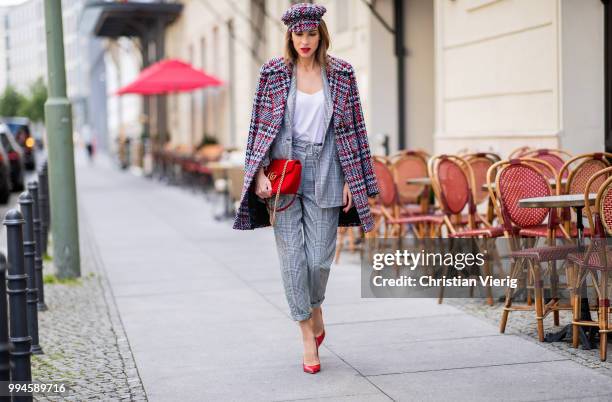 Alexandra Lapp wearing a checkered suit combination in black and white with a long blazer and high waist pants with an integrated belt both from...