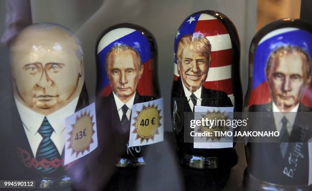 Russian Matryoshka dolls depicting Russian President Vladimir Putin and US President Donald Trump are on sale in the Ruslania book store in Helsinki...