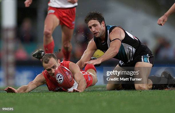 Daniel McPherson of the Swans dives infront of Darryl Wakelin of the Power during the AFL round 11 match between the Sydney Swans and Port Adelaide...