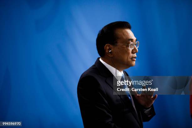 Chinese Premier Li Keqiang gestures speaks to the media together with German Chancellor Angela Merkel following Germany-China government...