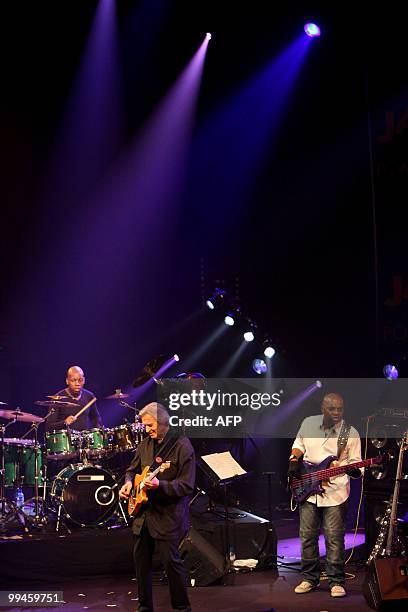 Jazz guitarist John Mc Laughlin , drummer Mark Mondesir and bass player Etienne MBappe perform during the 29th edition of "Sous les pommiers" jazz...