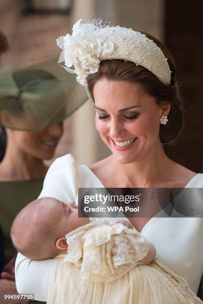 Catherine, Duchess of Cambridge carries Prince Louis as they arrive for his christening service at St James's Palace on July 09, 2018 in London,...