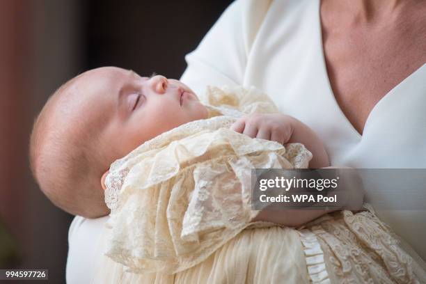 Catherine, Duchess of Cambridge carries Prince Louis as they arrive for his christening service at St James's Palace on July 09, 2018 in London,...