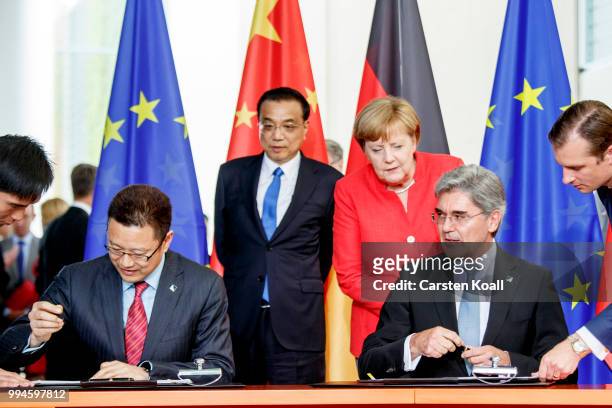 Chinese Premier Li Keqiang speaks and German Chancellor Angela Merkel look on as Qian Zhimin , Chairman of the Chinese company State Power...