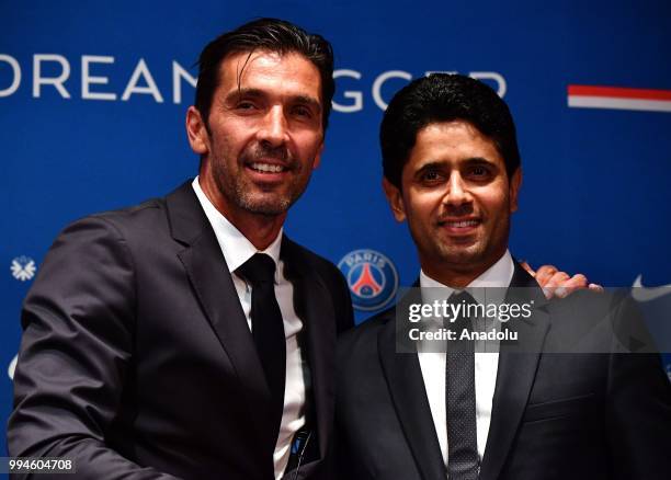 Paris Saint Germain's new goalkeeper Gianluigi Buffon and PSG's president Nasser Al-Khelaifi pose after official presentation press conference at...