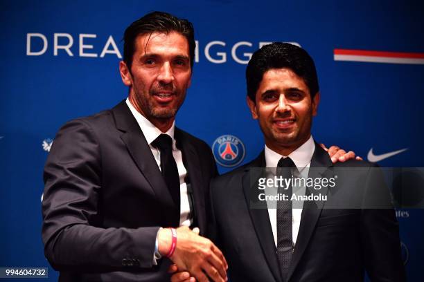 Paris Saint Germain's new goalkeeper Gianluigi Buffon and PSG's president Nasser Al-Khelaifi pose after official presentation press conference at...