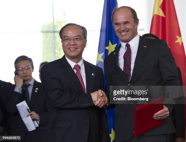 Lin Shaochun, executive vice governor of Guangdong Province, left, shakes hands with Martin Brudermueller, chief executive officer of BASF SE, during...