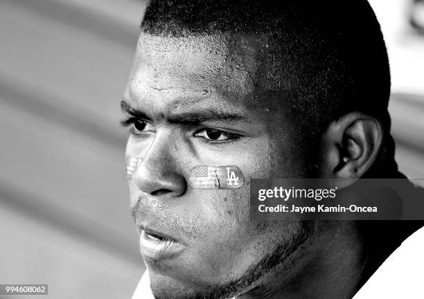 Yasiel Puig of the Los Angeles Dodgers sits in the dugout during the second inning in the third inning of the game against the Pittsburgh Pirates at...