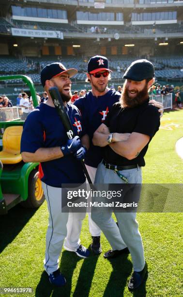 Max Stassi and Josh Reddick of the Houston Astros talk with NBC Sports California Analyst Dallas Braden on the field prior to the game against the...