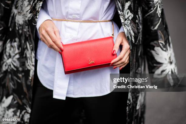 Alexandra Lapp wearing a long blazer jacket with floral prints in green, white and gold tones from Steffen Schraut, a white long shirt and slim...