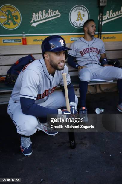 George Springer of the Houston Astros squats in the dugout prior to the game against the Oakland Athletics at the Oakland Alameda Coliseum on June...