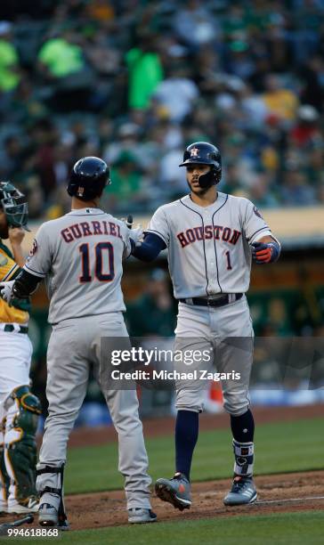 Carlos Correa of the Houston Astros is congratulated after hitting a home run during the game against the Oakland Athletics at the Oakland Alameda...