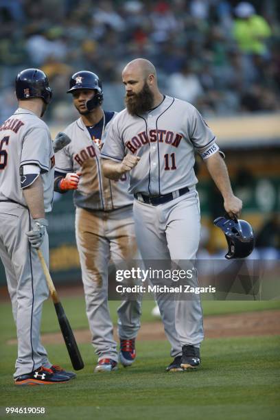 Evan Gattis of the Houston Astros celebrates after hitting a home run during the game against the Oakland Athletics at the Oakland Alameda Coliseum...