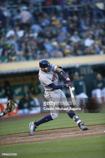 Carlos Correa of the Houston Astros bats during the game against the Oakland Athletics at the Oakland Alameda Coliseum on June 12, 2018 in Oakland,...