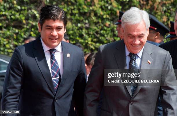 Costa Rican President Carlos Alvarado walks next to Chilean President Sebastian Pinera upon his arrival at the presidential house in San Jose, July...