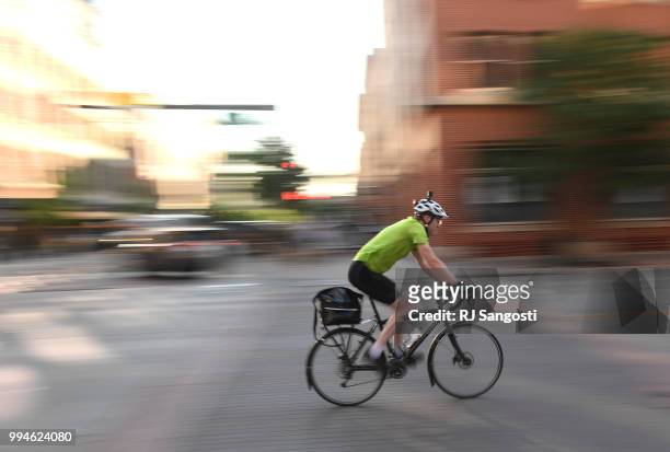 Biker rides near Intersection at Wynkoop St. And 15th St on July 9, 2018 in Denver, Colorado. Colorado Governor John Hickenlooper signed a bike law...
