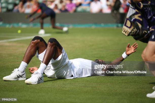 Mens Singles - Gael Monfils v Kevin Anderson - Gael Monfils reaches up for his towel after slipping over for a third time at All England Lawn Tennis...