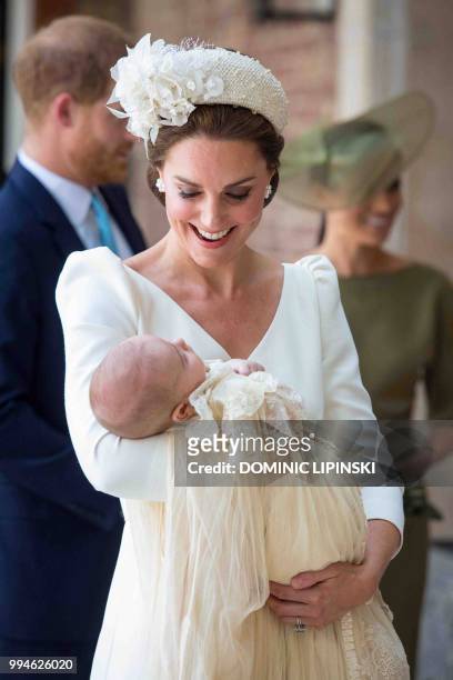 Britain's Catherine, Duchess of Cambridge holds Britain's Prince Louis of Cambridge on their arrival for his christening service at the Chapel Royal,...