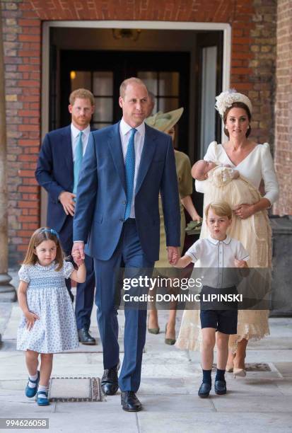 Britain's Princess Charlotte of Cambridge and Britain's Prince George of Cambridge hold hands with their father, Britain's Prince William, Duke of...