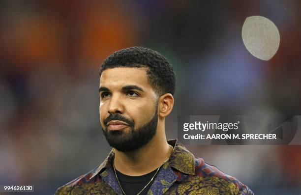 In this file photo taken on July 20, 2017 Rapper Drake looks on prior to the International Champions Cup soccer match between Manchester City against...