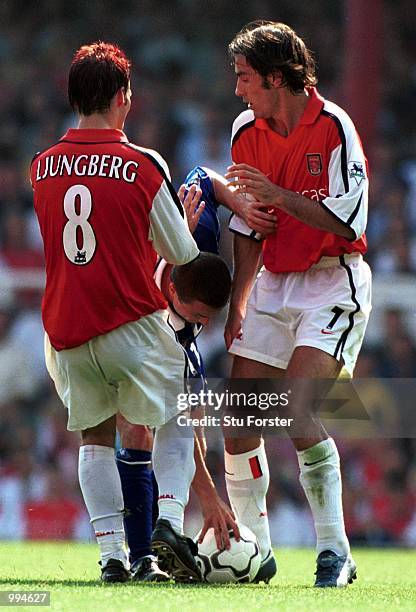 Fredrik Ljungberg and Robert Pires of Arsenal stop Dennis Wise of Leicester from taking a quick free kick during the FA Barclaycard Premiership match...