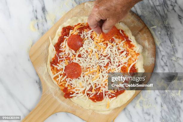 making a pizza - pepperoni pizza overhead stock pictures, royalty-free photos & images