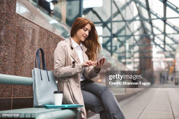 business woman using smart phone on city street - vancouver canada 2018 stock pictures, royalty-free photos & images