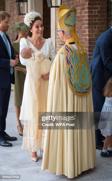 Catherine Duchess of Cambridge speaks to Archbishop of Canterbury Justin Welby as she arrives carrying Prince Louis for his christening service at...
