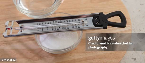 sugar thermometer, granulated sugar and water - granulated sugar stock pictures, royalty-free photos & images