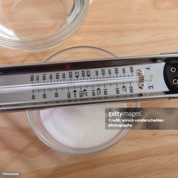 sugar thermometer, granulated sugar and water - granulated sugar stock pictures, royalty-free photos & images