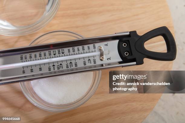 sugar thermometer, granulated sugar and water - granulated sugar stock pictures, royalty-free photos & images