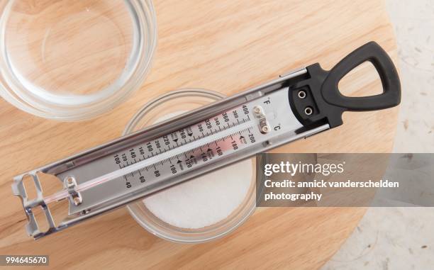 sugar thermometer, granulated sugar and water - granulated sugar stock pictures, royalty-free photos & images