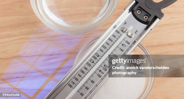 sugar thermometer, granulated sugar and water - granulated sugar stock pictures, royalty-free photos & images