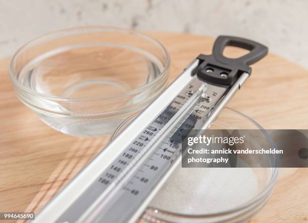 sugar thermometer, granulated sugar and water - granulated sugar stock pictures, royalty-free photos & images