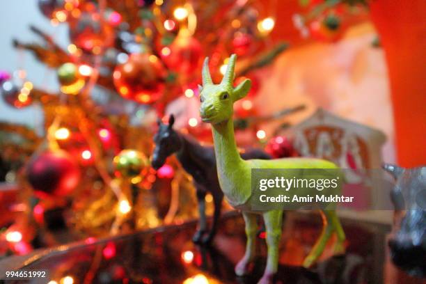 symbolic animals in front of christmas tree - amir mukhtar stock pictures, royalty-free photos & images