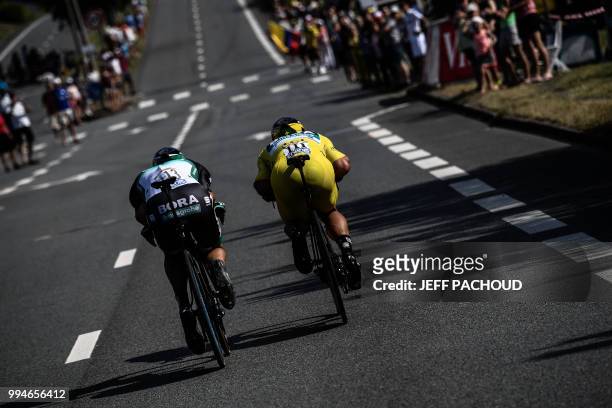 Slovakia's Peter Sagan, wearing the overall leader's yellow jersey and Germany's Marcus Burghardt ride during the third stage of the 105th edition of...