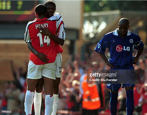 Kanu of Arsenal is congratulated on his goal by Thierry Henry as a dejected Frank Sinclair of Leicester looks on during the FA Barclaycard...
