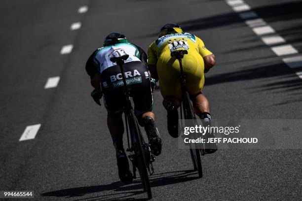 Slovakia's Peter Sagan, wearing the overall leader's yellow jersey and Germany's Marcus Burghardt ride during the third stage of the 105th edition of...