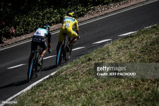 Slovakia's Peter Sagan, wearing the overall leader's yellow jersey and Germany's Marcus Burghardt ride during the third stage of the 105th edition of...