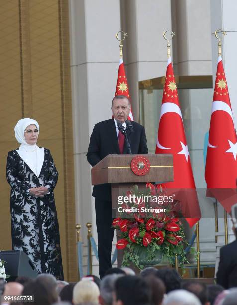 Turkey's President Tayyip Erdogan, accompanied by his wife Emine Erdogan, makes a speech during a ceremony at the Presidential Palace on July 9, 2018...