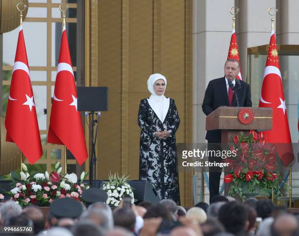 Turkey's President Tayyip Erdogan, accompanied by his wife Emine Erdogan, makes a speech during a ceremony at the Presidential Palace on July 9, 2018...