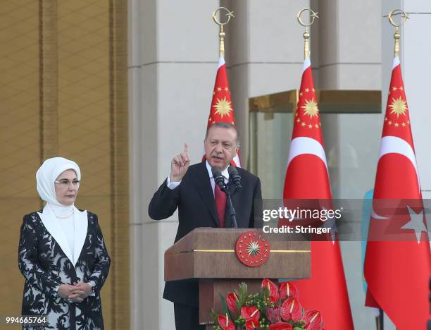 Turkey's President Tayyip Erdogan, accompanied by his wife Emine Erdogan, makes a speech during a ceremony at the Presidential Palace on July 9, 2018...