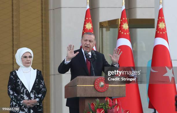 Turkey's President Tayyip Erdogan, accompanied by his wife Emine Erdogan, makes a speech during a ceremony at the Presidential Palace on July 9, 2018...