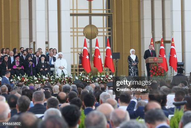 Turkey's President Tayyip Erdogan, accompanied by his wife Emine Erdogan, makes a speech during a ceremony at the Presidential Palace on July 9, 2018...